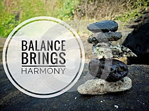 Life balance quote. Inspirational motivational quotes- Balance brings harmony. With sea stones balance formation on the big rock.