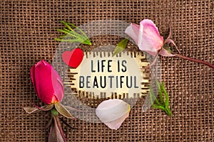 Life is beautiful written in hole on the burlap