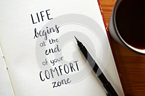 `LIFE BEGINS AT THE END OF YOUR COMFORT ZONE` hand-lettered in notebook