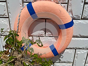 Life belt, rescue ring on a brick wall
