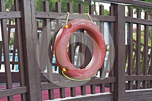 life belt, rescue ring on wooden wall buoy photo