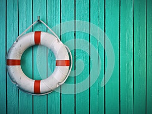 Life belt or rescue ring on wooden wall. Salvation, protection