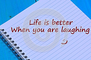 Life is better when you are laughing words on notebook