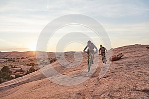 Life is better when youre biking. Full length shot of two young male athletes mountain biking in the wilderness.