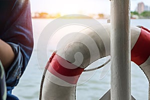 Life buoy attached to fence on the cruise ship,Selective focus