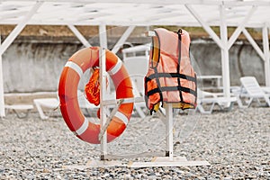 Life buoy on the beach and life jacket