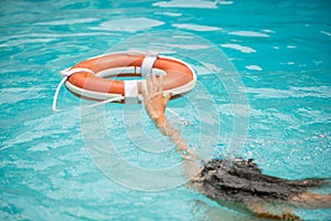 Life buoy, concept of help, rescue. Lifebuoy in water. Life ring floating in a sea, life preserver. Rescue ring