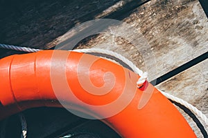 Life buoy hanging on wooden wall