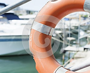 Life buoy hung on a railing in the port.