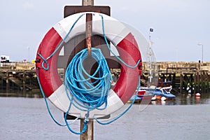Life buoy on a post at a harbour