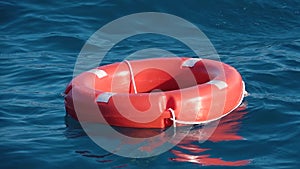 Life buoy or rescue buoy floating on sea to rescue people from drowning man. Slow motion. Close up