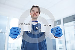 Life, choice and doctor with paper in hands for abortion, human rights or decision in clinic. Nurse, poster and support