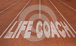 Life Coach written on running track, New Concept on running track text in white color