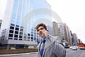 Life in the fast lane. A cropped shot of a handsome young businessman talking on his cellphone in the city.