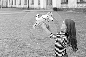 Life full of fun. Happy kid play with toy dog outdoors. Enjoying playtime. Play and fun. Childhood fun. Leisure and free