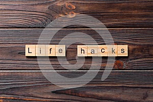 life hacks word written on wood block. life hacks text on table, concept