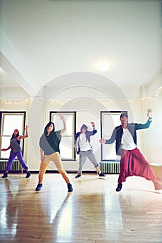 Life happens when you get moving. a group of young people dancing together in a studio.