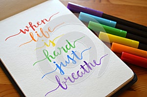 WHEN LIFE IS HARD JUST BREATHE hand-lettered in notebook