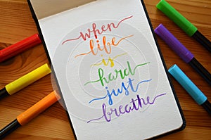 WHEN LIFE IS HARD JUST BREATHE hand-lettered in notebook