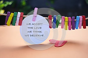 Life inspirational and motivational quote - We accept the love we think we deserve. On colorful background. photo