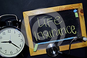 Life Insurance handwriting on chalkboard on top view.