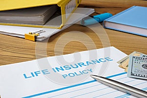 Life insurance policy, money and documents.