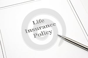 Life Insurance Policy with a pen to sign.