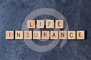 `Life Insurance` spelled out in wooden letter tiles photo