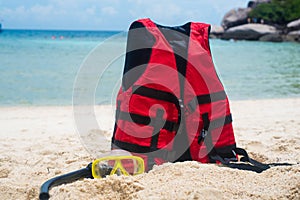 Life jacket and a mask for snorkeling on the beach