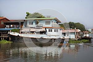 Life lifestyle of thai people at chaopraya riverside with boat and ship in fishing village for traveler travel visit at Ing Nam