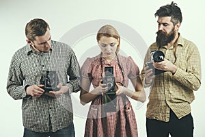 Life is like a camera. Retro style woman and men hold analog photo cameras. Group of photographers with retro cameras