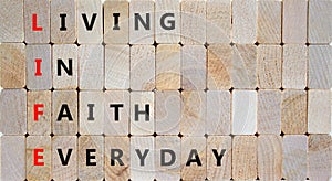 LIFE living in faith everyday symbol. Concept words LIFE living in faith everyday on wooden blocks on beautiful wooden background