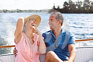 Life is one refreshing journey. a mature couple enjoying a relaxing boat ride.