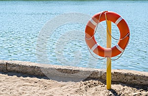 Life preserver on the shore of the lake to rescue drowning