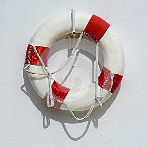 Life preserver on the white wall