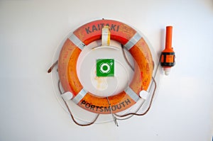 Life preservers on white wall. Life buoy on the deck of cruise ship.