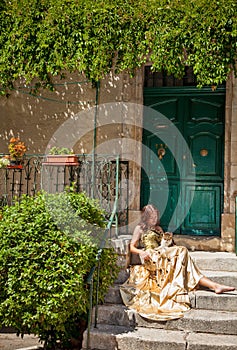 Life in Provence. Woman sitting on the porch and stroking a cat