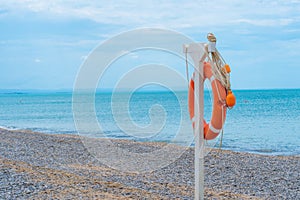 Life ring beach sea buoy orange closeup saving rescue round, concept red guard from emergency from ocean assistance