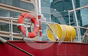 Life ring and yellow barrel and sailing equipment on ship
