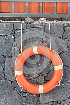 Life saving ring mounted on a lava wall