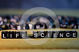 LIFE SCIENCE concept wooden blocks on the table.