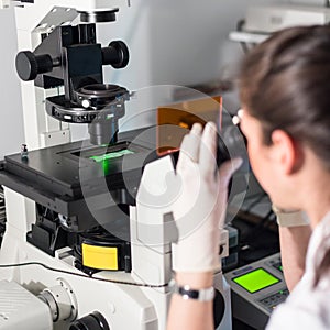 Life science researcher microscoping in genetic scientific laboratory.