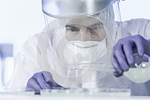 Life scientist researching in bio hazard laboratory. High degree of protection work. photo