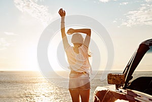 Life is simple, explore more. a happy young woman enjoying a summers road trip.