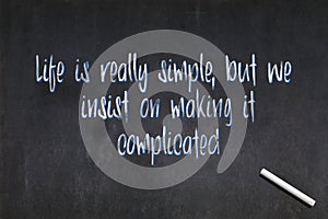 Life is really simple, but we insist on making it complicated - Confucius quote on a blackboard