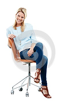 Life is simple. Relax and be happy. Studio portrait of a happy young woman sitting on a chair against a white background