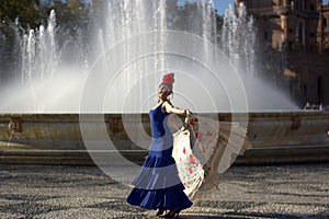 The happy woman dancing in front of the fountain photo