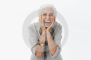 Life only starts when get older. Portrait of charming happy and carefree european senior woman with grey hair laughing