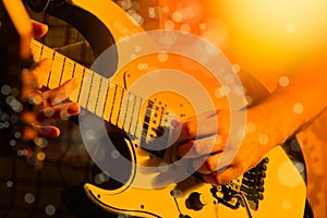 Life style image of close up young male guitarist hand, playing