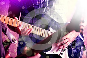 Life style image of close up young male guitarist hand, playing